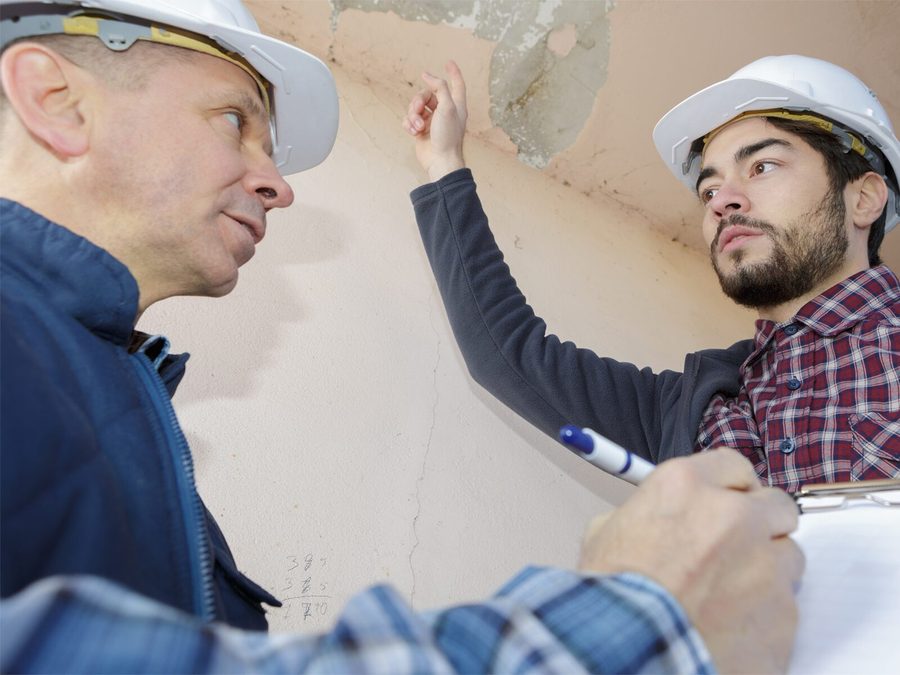 Contractor inspecting water damage in a Brooklyn property